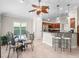 Bright breakfast nook with glass table, unique chairs, and a view of the yard at 654 Poinsett Ct, The Villages, FL 32162