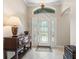 Bright foyer featuring tile floors, a decorative glass front door, and stylish furniture at 654 Poinsett Ct, The Villages, FL 32162