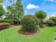Lush front yard featuring manicured shrubs and landscaping, creating a welcoming curb appeal at 654 Poinsett Ct, The Villages, FL 32162