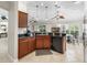 Charming kitchen features dark granite counters and wood cabinets at 654 Poinsett Ct, The Villages, FL 32162