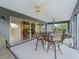 Relaxing screened lanai with multiple seating areas and ceiling fans at 654 Poinsett Ct, The Villages, FL 32162