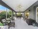 Expansive screened lanai with seating, dining and ceiling fans for comfort at 654 Poinsett Ct, The Villages, FL 32162