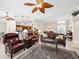 Open living space with a ceiling fan, bar seating, and an adjacent dining area at 654 Poinsett Ct, The Villages, FL 32162
