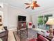 Bright living room with a decorative ceiling fan, patio access, and comfortable seating at 654 Poinsett Ct, The Villages, FL 32162