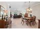 Open-concept living and dining area featuring tile floors, ceiling fans and large windows at 654 Poinsett Ct, The Villages, FL 32162