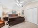 Spacious bedroom featuring a ceiling fan, nightstands, and large closet at 654 Poinsett Ct, The Villages, FL 32162