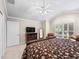Bright main bedroom features a tray ceiling, plantation shutters, and neutral color palette at 654 Poinsett Ct, The Villages, FL 32162