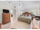 Bright main bedroom with a ceiling fan, large bed, and shuttered windows at 654 Poinsett Ct, The Villages, FL 32162