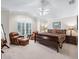 Spacious main bedroom with leather armchairs and shuttered windows at 654 Poinsett Ct, The Villages, FL 32162