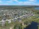 Aerial view showcasing neighborhood with waterfront properties and stunning lake views at 686 Black Eagle Dr, Groveland, FL 34736