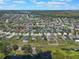 Aerial view showcasing a community with lake views and well-maintained properties at 686 Black Eagle Dr, Groveland, FL 34736