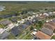 Expansive aerial view of a suburban neighborhood with well-maintained homes and lush green surroundings and pond views at 686 Black Eagle Dr, Groveland, FL 34736