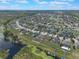 Aerial shot displaying a neighborhood, some waterfront and water access at 686 Black Eagle Dr, Groveland, FL 34736