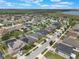Aerial view of neighborhood with modern homes, some with solar panels on roofs at 686 Black Eagle Dr, Groveland, FL 34736