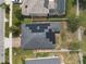 Aerial view of a house with solar panels on the roof in a residential neighborhood at 686 Black Eagle Dr, Groveland, FL 34736