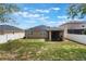 View of backyard featuring solar panels, fenced yard and screened lanai at 686 Black Eagle Dr, Groveland, FL 34736