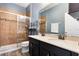Bathroom with a double vanity, granite countertop, tiled shower and blue walls at 686 Black Eagle Dr, Groveland, FL 34736