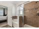Bathroom featuring separate shower and tub, tiled walls, and a view to the main bedroom at 686 Black Eagle Dr, Groveland, FL 34736