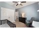 Neutral Bedroom showcasing modern baby furniture, soft carpet, and light blue walls at 686 Black Eagle Dr, Groveland, FL 34736