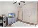 Bedroom featuring carpeted floors, a double door closet, and a large window at 686 Black Eagle Dr, Groveland, FL 34736
