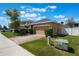Charming single Gathering home featuring a paved driveway, attached garage, and manicured landscaping at 686 Black Eagle Dr, Groveland, FL 34736