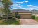 Lovely single-story home with a two-car garage, neat landscaping, and a welcoming front entrance at 686 Black Eagle Dr, Groveland, FL 34736