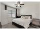 Cozy bedroom featuring a neutral color palette, ceiling fan, and a large window allowing for abundant natural light at 686 Black Eagle Dr, Groveland, FL 34736