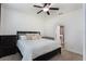 Bright main bedroom with a ceiling fan, neutral carpet, and an en-suite bathroom for added comfort and convenience at 686 Black Eagle Dr, Groveland, FL 34736