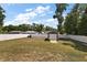 Spacious backyard enclosed by a white fence, featuring a shed with a roll-up door at 7162 Se 124Th St, Belleview, FL 34420