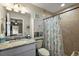Cozy bathroom featuring tile shower, seashell decor, and white vanity at 7162 Se 124Th St, Belleview, FL 34420