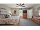 Spacious bedroom features floral bedding, ceiling fan, and natural light at 7162 Se 124Th St, Belleview, FL 34420