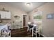 Bright breakfast nook with wood floors, a window and table for four offers cozy dining at 7162 Se 124Th St, Belleview, FL 34420