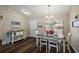 Traditional dining room with wood floors and a chandelier provides a warm atmosphere at 7162 Se 124Th St, Belleview, FL 34420