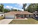Beautiful single-story home with lovely landscaping and an American flag in the front yard at 7162 Se 124Th St, Belleview, FL 34420