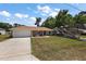 Charming single-story home with a well-manicured lawn and spacious driveway, plus RV parking at 7162 Se 124Th St, Belleview, FL 34420