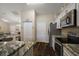 Open kitchen with granite countertops and stainless steel appliances overlooking the living spaces at 7162 Se 124Th St, Belleview, FL 34420