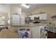 Bright kitchen features granite countertops, stainless steel appliances, and white cabinetry at 7162 Se 124Th St, Belleview, FL 34420