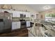 Bright kitchen featuring granite countertops and stainless steel appliances at 7162 Se 124Th St, Belleview, FL 34420