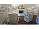 Open concept living room has wood floors, a media center, and lots of natural light at 7162 Se 124Th St, Belleview, FL 34420