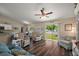 The living room boasts wood floors, natural light, and sliding glass doors to the backyard at 7162 Se 124Th St, Belleview, FL 34420
