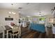 Open concept living area with wood floors, dining area, and living area with lots of natural light at 7162 Se 124Th St, Belleview, FL 34420