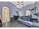 Bedroom with purple accent wall, ceiling fan, and a window providing natural light at 802 Balmoral Dr, Davenport, FL 33896