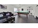 Cozy game room with a pool table, comfortable seating, and dark hardwood flooring at 802 Balmoral Dr, Davenport, FL 33896