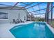 Spacious screened-in pool area with lounge seating and a dining set for outdoor enjoyment at 802 Balmoral Dr, Davenport, FL 33896