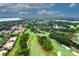 Scenic aerial view of a golf course community with lush green fairways and well-maintained landscaping at 9220 San Jose Blvd, Howey In The Hills, FL 34737
