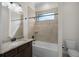 Bathroom featuring a large mirror, vanity, and a shower-tub combination with tiled walls at 9220 San Jose Blvd, Howey In The Hills, FL 34737
