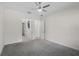 Empty bedroom with multiple doors and a ceiling fan, offering ample space and potential uses at 9220 San Jose Blvd, Howey In The Hills, FL 34737