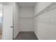 Walk-in closet with carpet flooring, a white door, and wire shelving for storage and organization at 9220 San Jose Blvd, Howey In The Hills, FL 34737