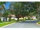 Street view of the San Jose neighborhood with mature trees and well-maintained landscaping in a desirable location at 9220 San Jose Blvd, Howey In The Hills, FL 34737
