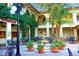 Charming courtyard featuring outdoor seating, lush greenery, potted flowers, and a tranquil fountain at 9220 San Jose Blvd, Howey In The Hills, FL 34737